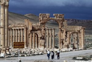 A picture taken on March 14, 2014 shows Syrian citizens walking in the ancient oasis city of Palmyra, 215 kilometres northeast of Damascus. From the 1st to the 2nd century, the art and architecture of Palmyra, standing at the crossroads of several civilizations, married Graeco-Roman techniques with local traditions and Persian influences. AFP PHOTO/JOSEPH EID (Photo credit should read JOSEPH EID/AFP/Getty Images)
