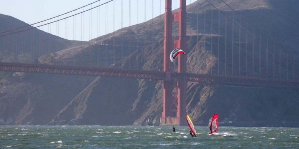 image: windsurfers under Golden Gate Bridge